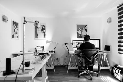 Hombre trabajando con ordenadores en su casa